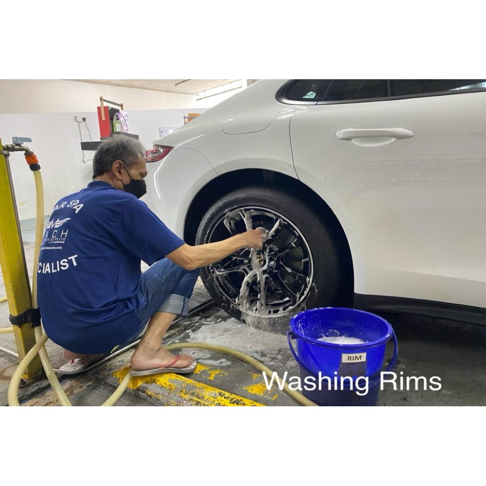 Premium Photo  Man cleans auto with car rim cleaner, carwash